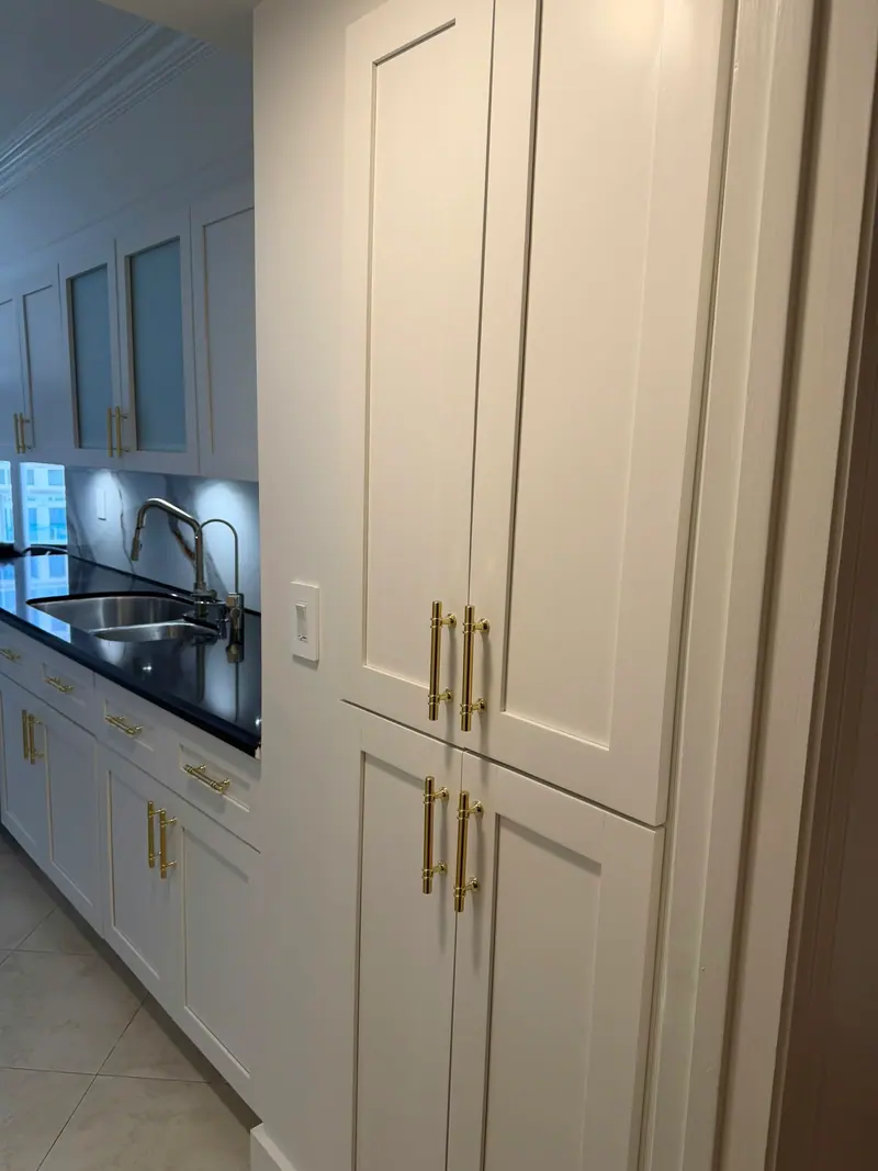 After painting: tall pantry cabinets in white with gold hardware, Sunny Isles Beach