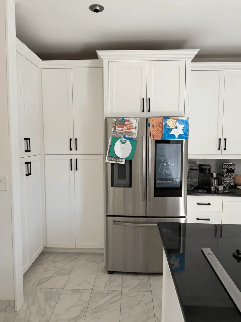 After: tall white pantry cabinets beside the refrigerator, Hallandale Beach