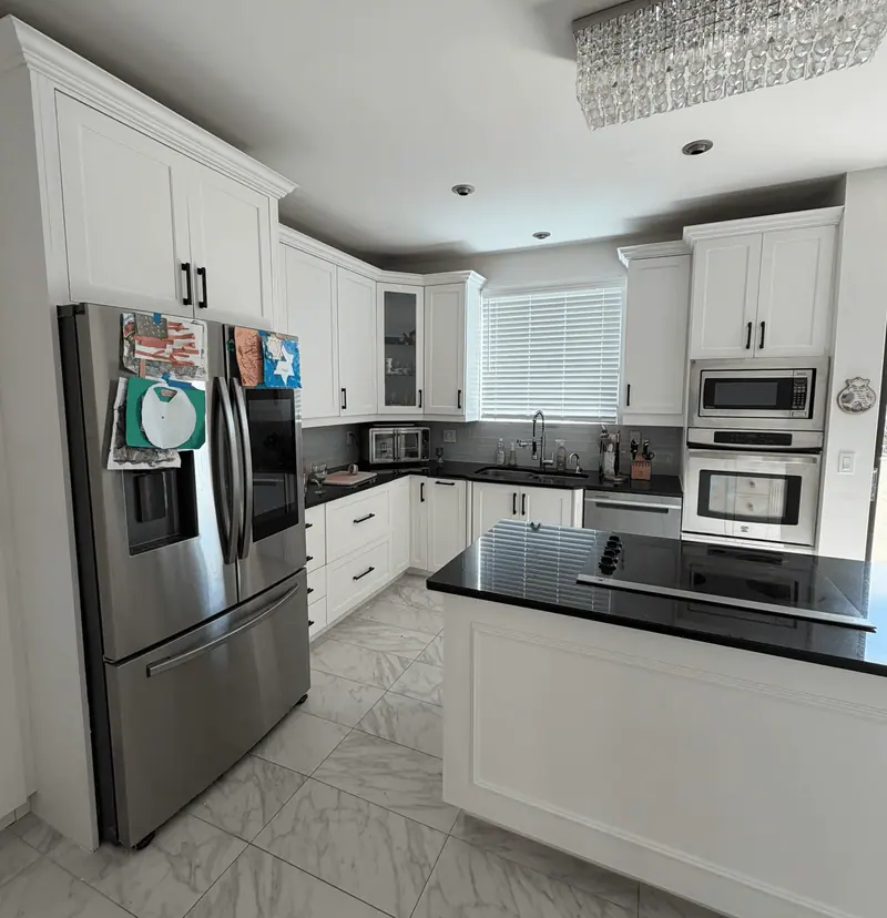 After: wide view of the refinished white kitchen with double wall oven, Hallandale Beach