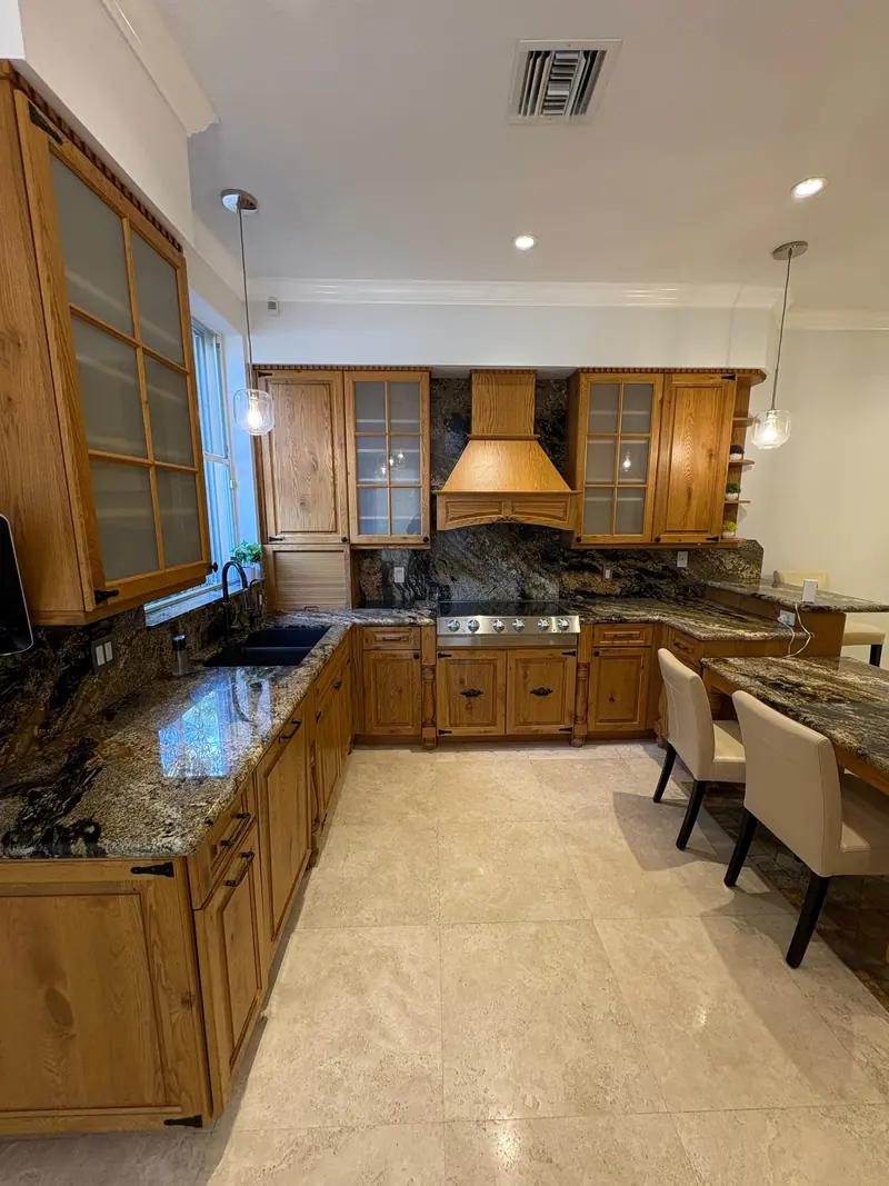 Aventura kitchen before painting, original oak cabinets and stone countertops