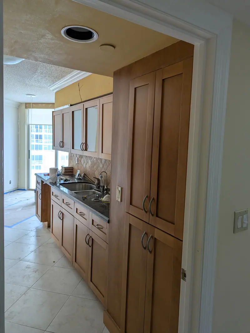 Before painting: wood pantry cabinets and galley kitchen, Sunny Isles Beach