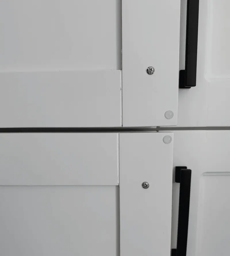 Detail of refinished white shaker doors and hardware