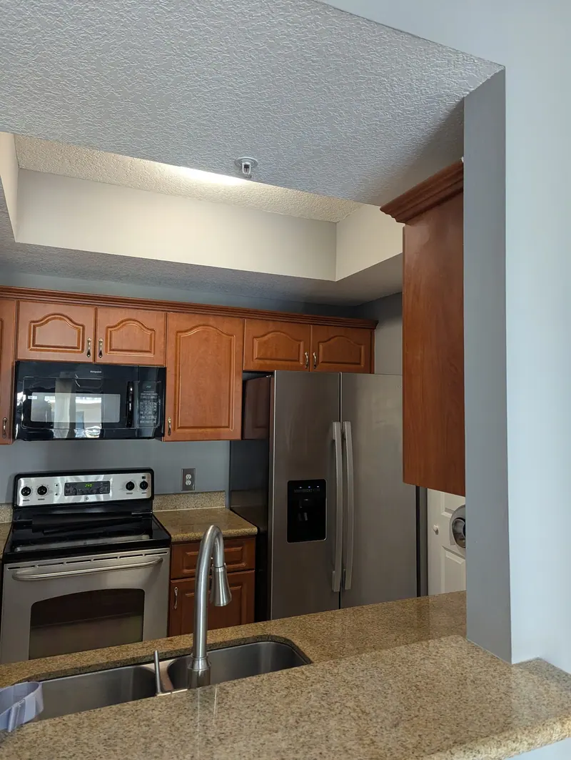 Expert cabinet painting that refreshes this kitchen with a brighter, modern look and a smooth, high-quality finish.