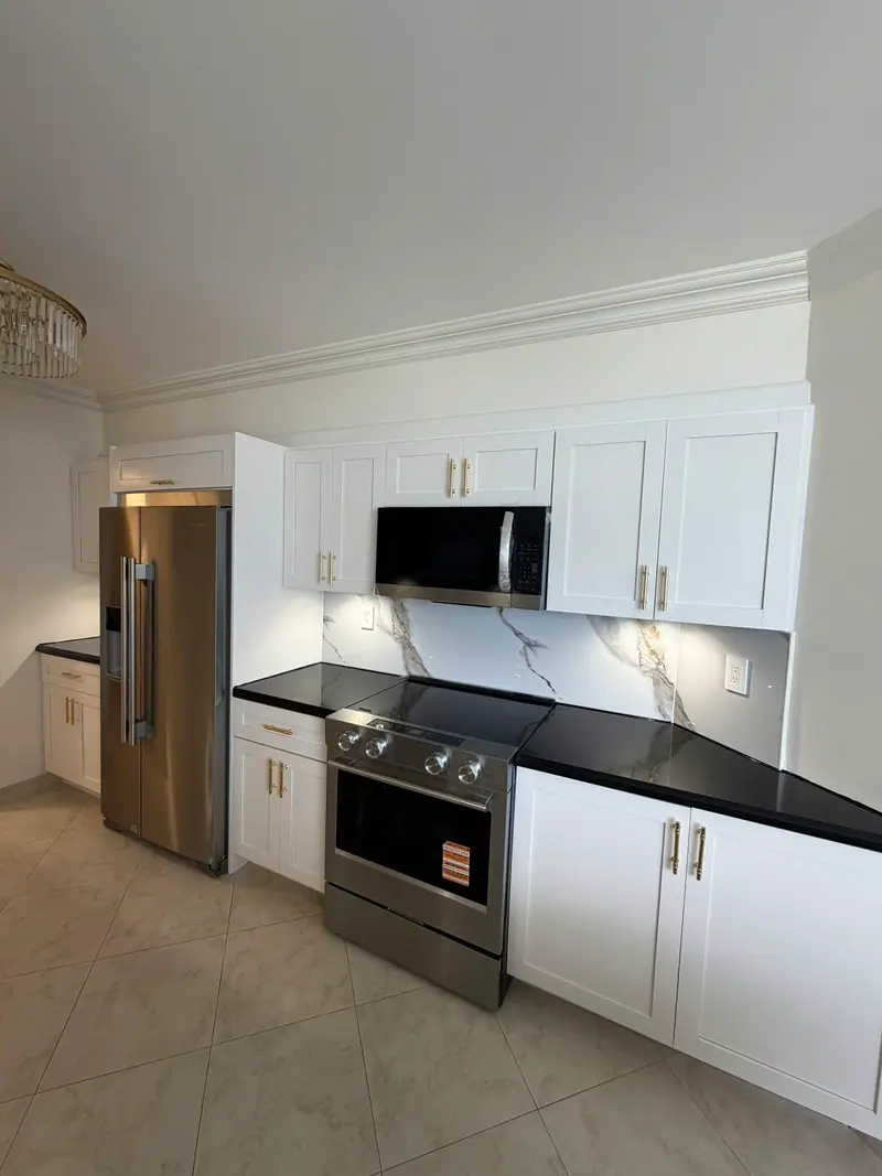 Finished white shaker cabinets with black countertops and stainless appliances, Sunny Isles Beach