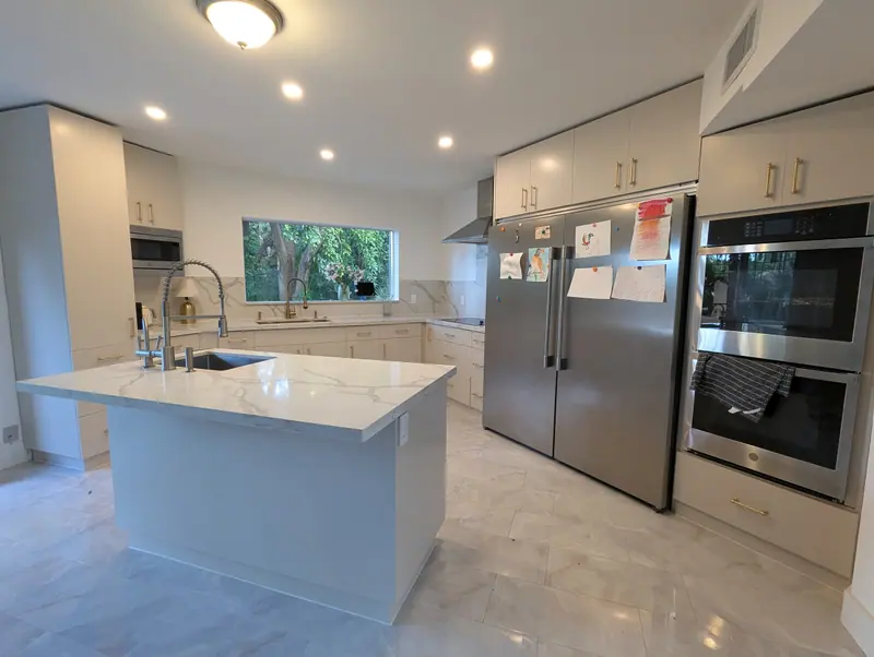Fort Lauderdale kitchen after refinishing, cabinets in Accessible Beige with white island and stainless appliances