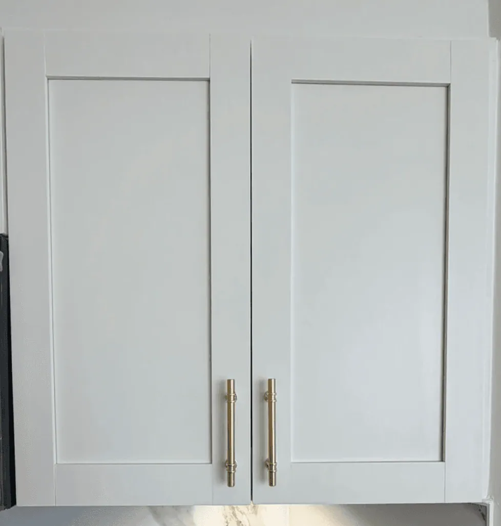 The same shaker cabinet doors after painting in white Alabaster with gold pulls