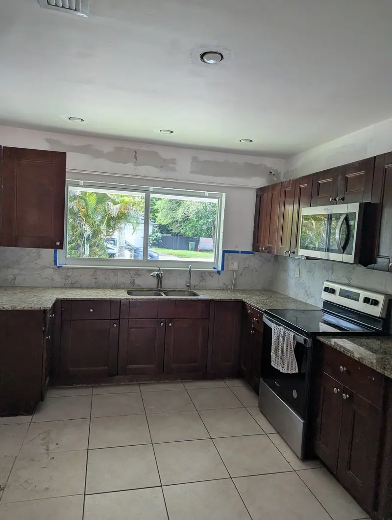 North Miami kitchen before refinishing, dark espresso cabinets and granite countertops