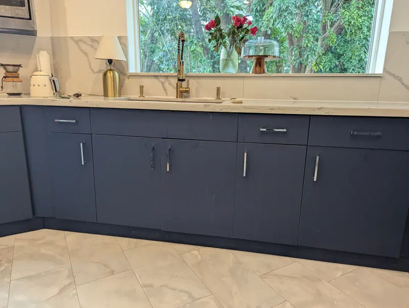 This photo shows the cabinets before painting, with visible damage caused by kitchen grease on the surface. With the proper preparation and professional process, we can restore your kitchen without the need for a full replacement, saving you hundreds of dollars.